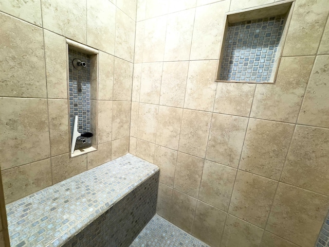 bathroom featuring a tile shower