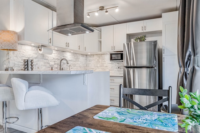 1002 S Kihei Rd Unit 205, Kihei, HI 96753 - kitchen featuring stainless steel appliances, island range hood, open shelves, tasteful backsplash, and white cabinetry