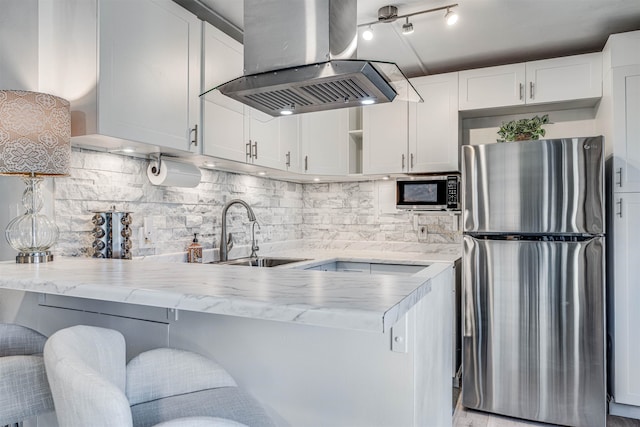 1002 S Kihei Rd Unit 205, Kihei, HI 96753 - kitchen with appliances with stainless steel finishes, island range hood, a sink, white cabinetry, and open shelves