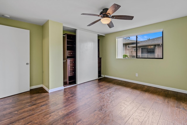 unfurnished bedroom featuring ceiling fan, a closet, and dark hardwood / wood-style flooring