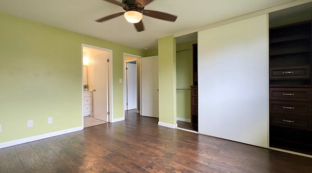 unfurnished bedroom featuring ceiling fan, dark wood-type flooring, and ensuite bathroom