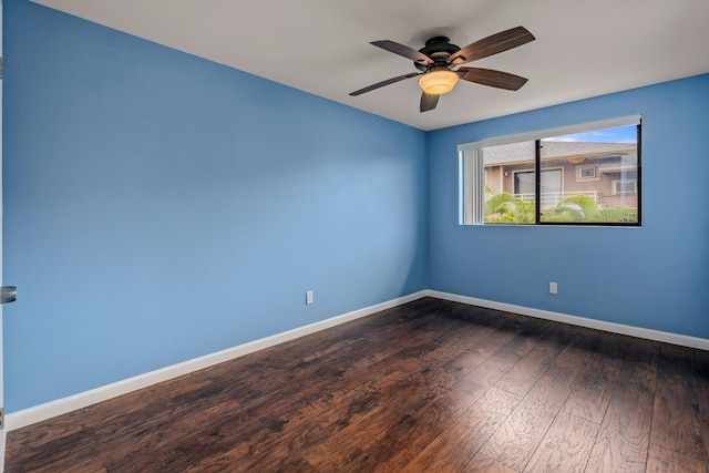 empty room featuring ceiling fan and dark hardwood / wood-style floors