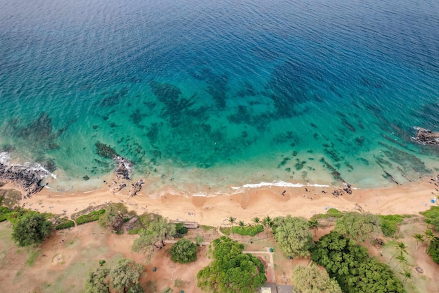 birds eye view of property featuring a water view and a beach view