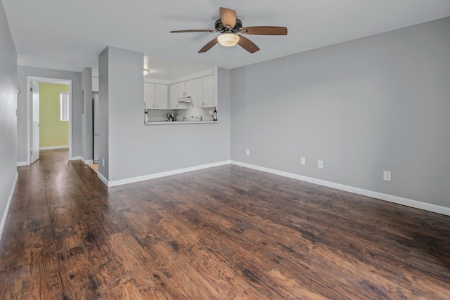 unfurnished living room featuring ceiling fan and dark hardwood / wood-style floors