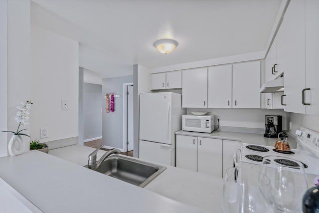 kitchen with sink, white cabinets, and white appliances