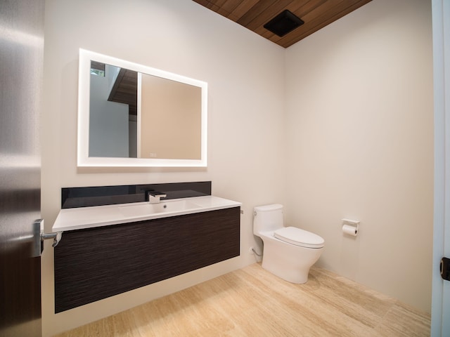 bathroom featuring vanity, toilet, and wood ceiling