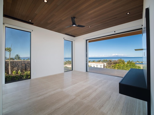 interior space featuring a water view and ceiling fan