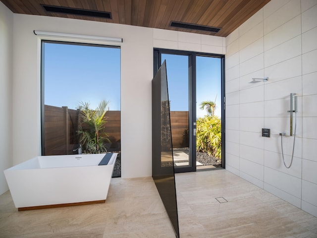 bathroom with plenty of natural light and wood ceiling