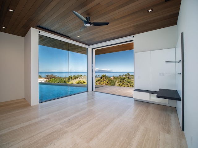 spare room with floor to ceiling windows, wooden ceiling, and light hardwood / wood-style floors