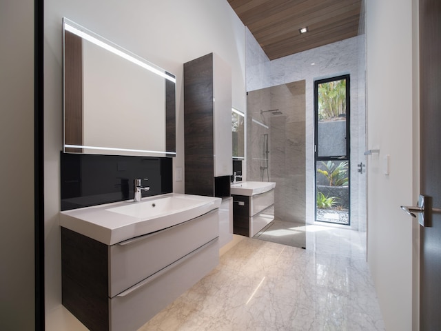 bathroom with double sink vanity, tile floors, wooden ceiling, a tile shower, and tile walls