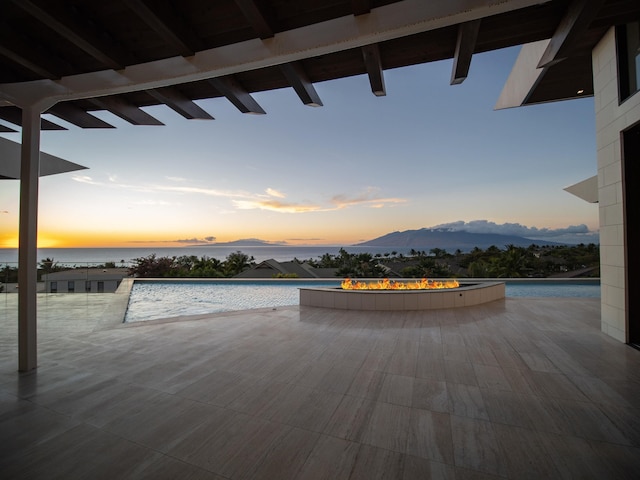 property view of water featuring a fire pit