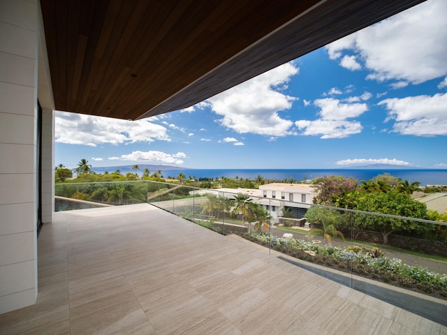 wooden terrace featuring a water view