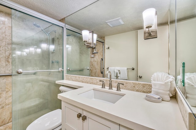 bathroom with walk in shower, vanity, and toilet