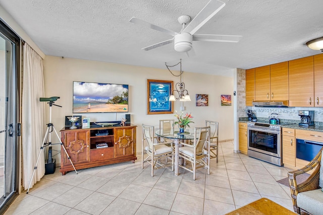 dining area with a textured ceiling, ceiling fan with notable chandelier, and light tile patterned flooring