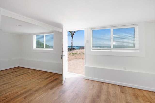 empty room featuring baseboards and wood finished floors