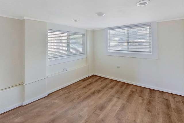 empty room featuring baseboards and wood finished floors