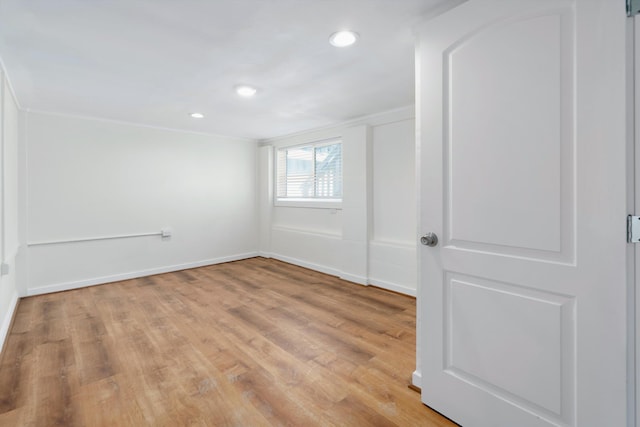spare room featuring baseboards, light wood finished floors, and recessed lighting