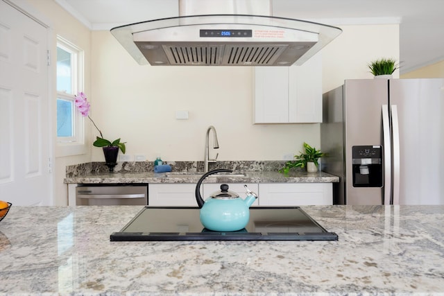 kitchen with white cabinets, light stone countertops, stainless steel appliances, and under cabinet range hood