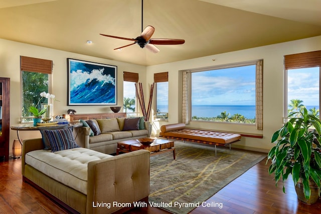 living room featuring plenty of natural light, a water view, and dark hardwood / wood-style floors