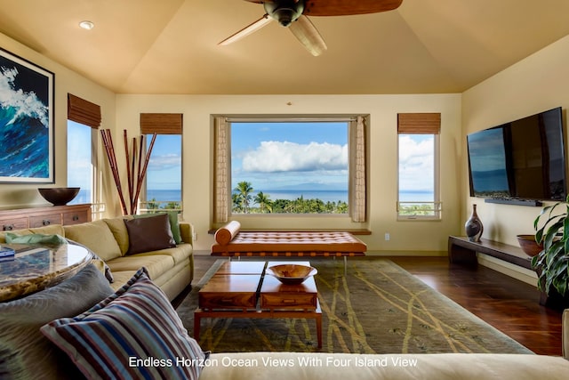 living room with ceiling fan, dark hardwood / wood-style flooring, and vaulted ceiling