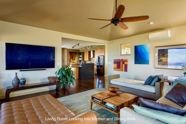 living room featuring rail lighting, hardwood / wood-style flooring, a wall mounted AC, and ceiling fan