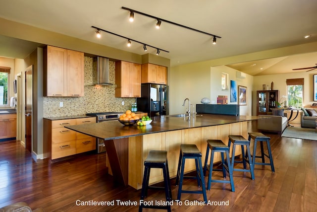 kitchen featuring stainless steel range, black fridge with ice dispenser, dark wood-type flooring, and wall chimney range hood