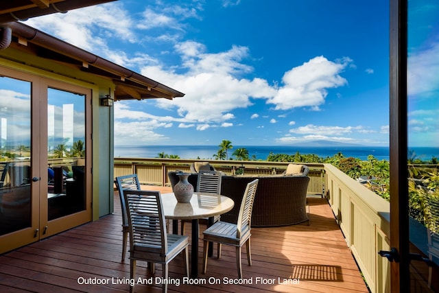 wooden terrace featuring a water view