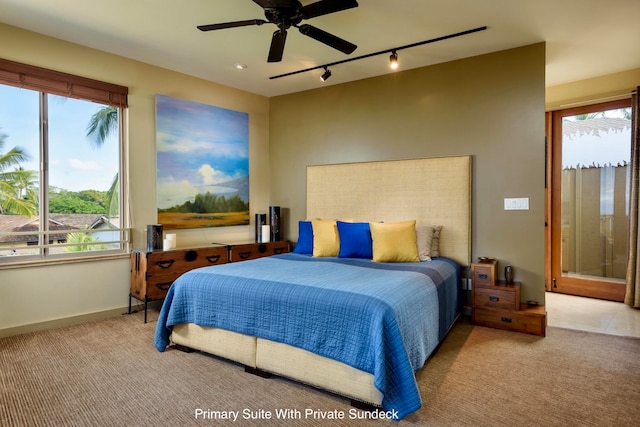 bedroom with ceiling fan, rail lighting, and light colored carpet