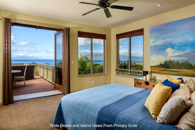 carpeted bedroom featuring ceiling fan and a water view