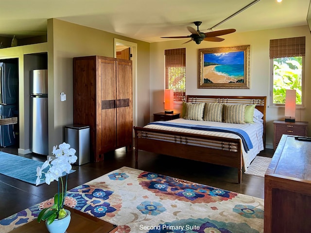 bedroom with black fridge, stainless steel refrigerator, and ceiling fan