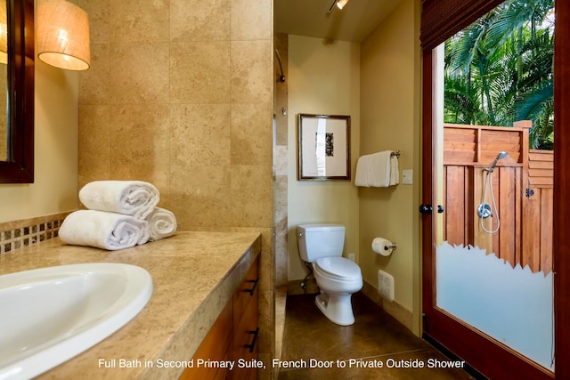 bathroom featuring toilet, tile patterned floors, and sink