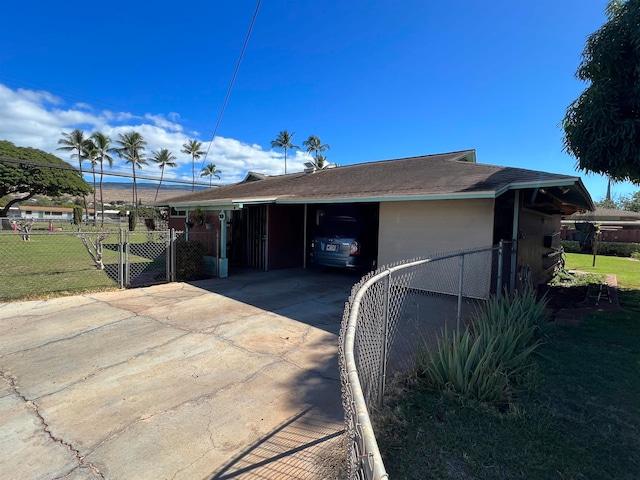 exterior space with a carport and a front yard