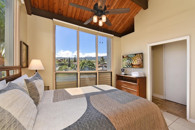 tiled bedroom with beamed ceiling, ceiling fan, wood ceiling, and high vaulted ceiling