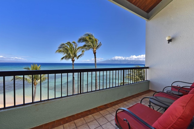 balcony with a water view and a beach view