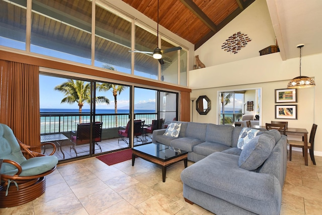 living room featuring ceiling fan, a water view, a healthy amount of sunlight, and high vaulted ceiling