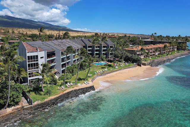 drone / aerial view with a beach view and a water view