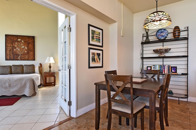 dining room featuring french doors and light tile patterned floors