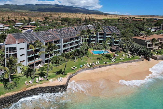 aerial view featuring a view of the beach and a water and mountain view