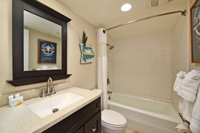 full bathroom featuring vanity, shower / tub combo, and toilet