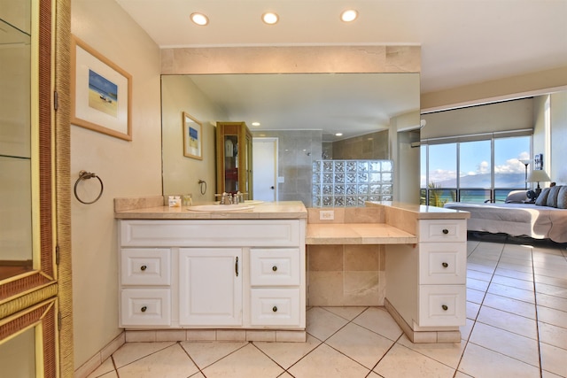 bathroom with tile patterned floors, a water view, and vanity