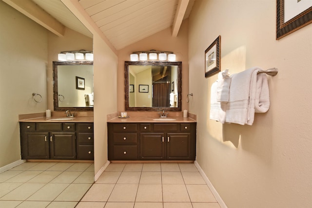 bathroom featuring tile patterned flooring, vaulted ceiling with beams, and vanity