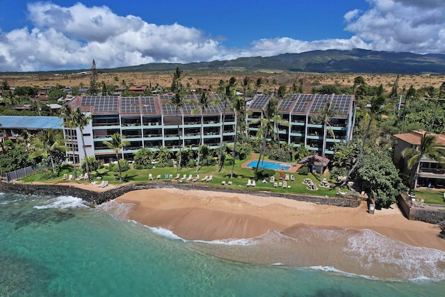 birds eye view of property featuring a view of the beach and a water and mountain view