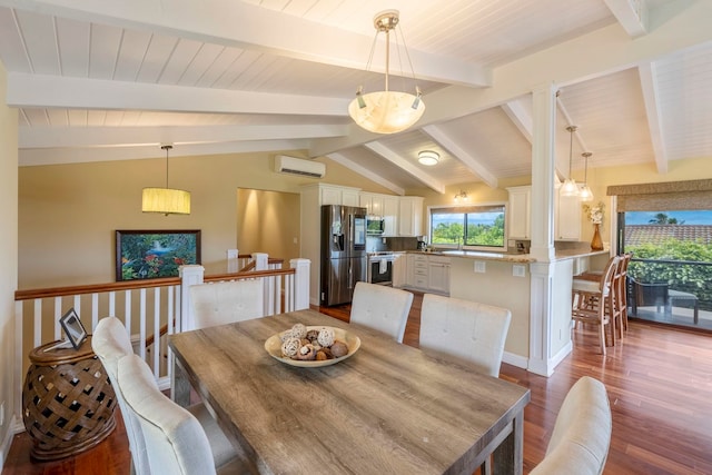 dining area with vaulted ceiling with beams, hardwood / wood-style floors, plenty of natural light, and a wall mounted AC