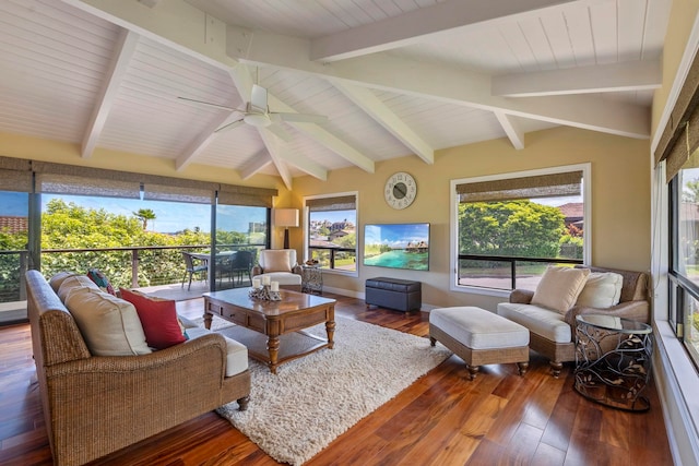 sunroom with beamed ceiling, ceiling fan, and a wealth of natural light