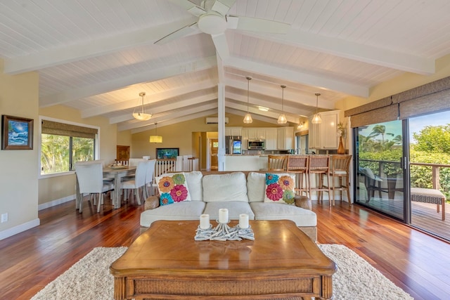 living room with hardwood / wood-style flooring, ceiling fan, and lofted ceiling with beams