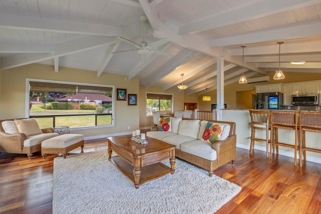 living room with ceiling fan, wood-type flooring, and vaulted ceiling with beams