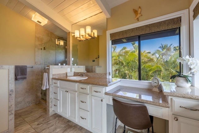 bathroom with a healthy amount of sunlight, walk in shower, wood ceiling, and vanity