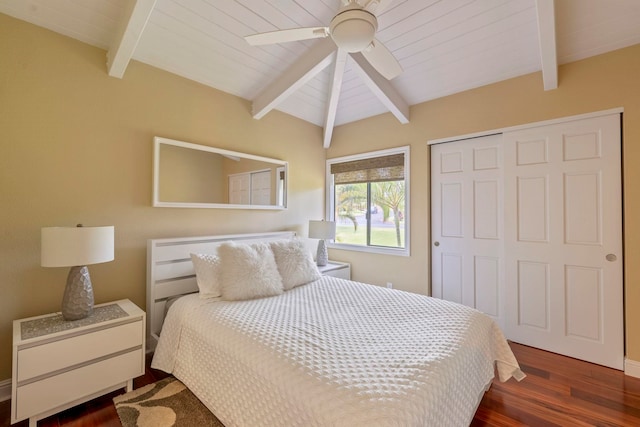 bedroom with dark hardwood / wood-style flooring, a closet, ceiling fan, and beamed ceiling