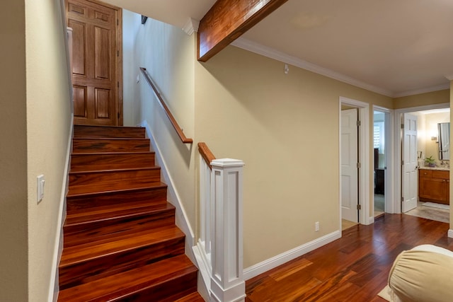 staircase with hardwood / wood-style floors and crown molding