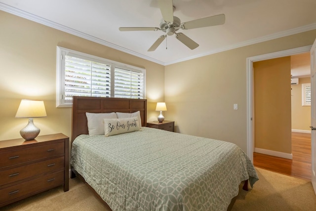 carpeted bedroom with ceiling fan and ornamental molding